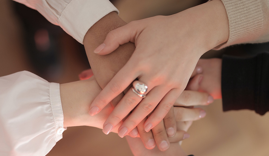 Stacked hands as a symbol of unity