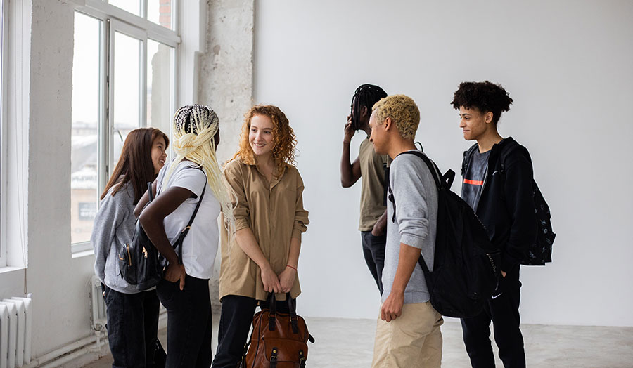 A group of young people from different ethnic backgrounds socialising with each other