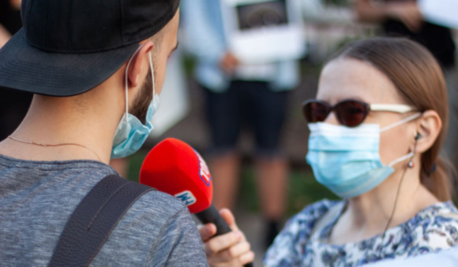 A journalist is interviewing a passerby