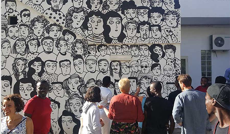 a group of people looking at a mural