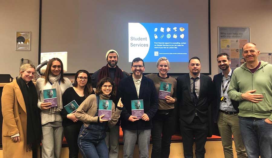 A group of people holding copies of Sebastian Cordoba's book 'Non-binary gender identities'