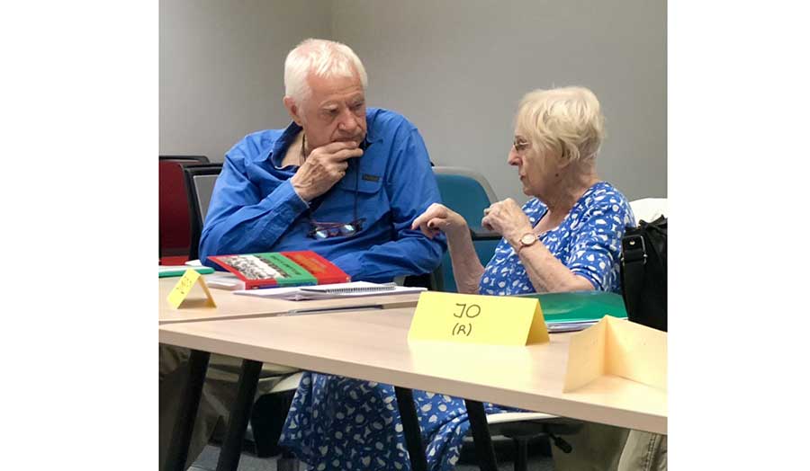 Two elderly students in discussion
