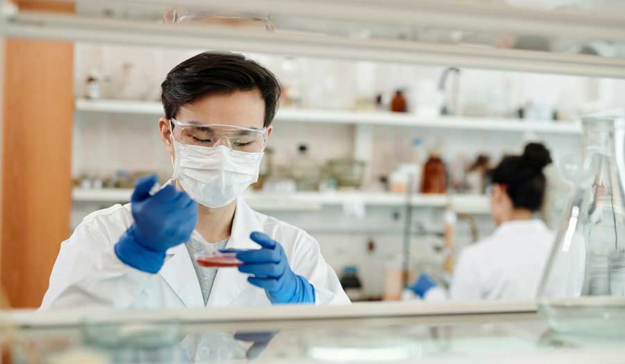A scientist in the lab working on the sample