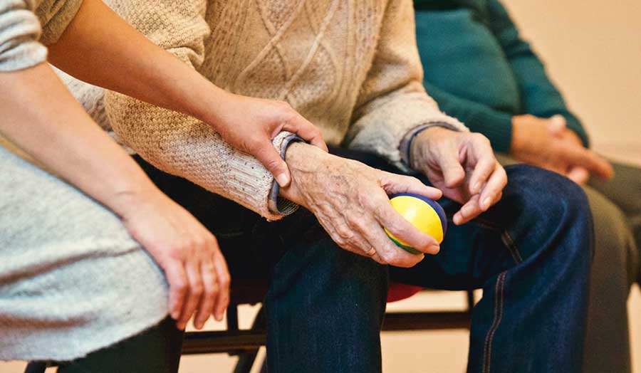 Young person's hand holding an older person's hand