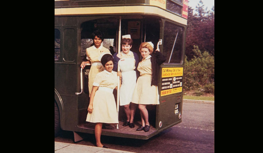 Four nurses standing on the bus deck 