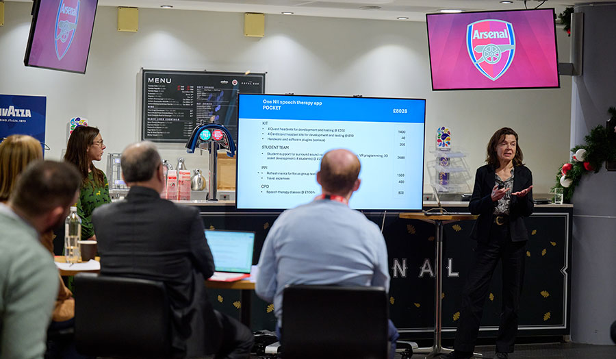 A person gives a presentation to a room of people