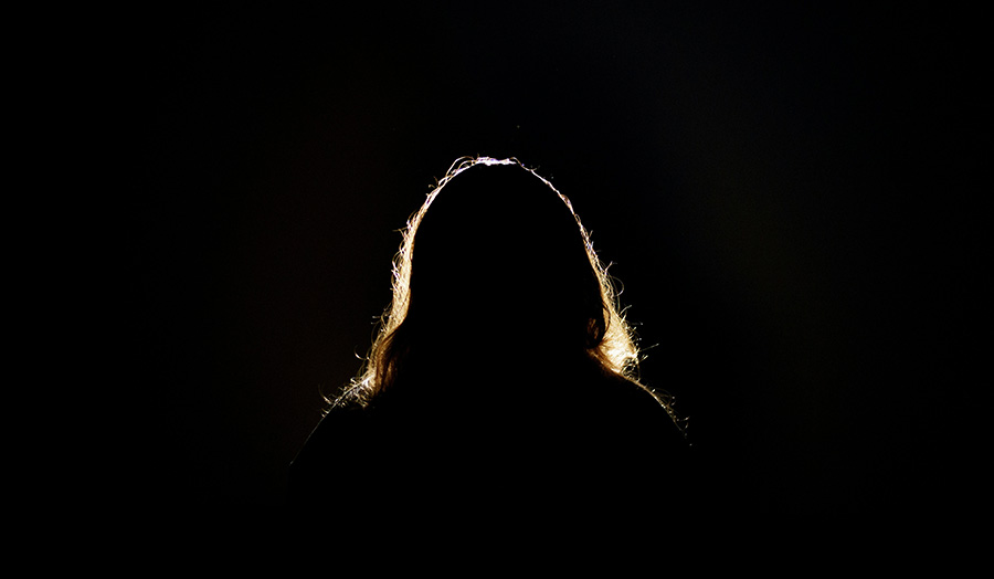 A backlit woman's head