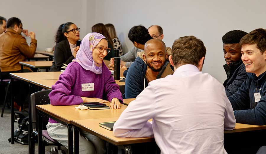 A group of people smiling and chatting
