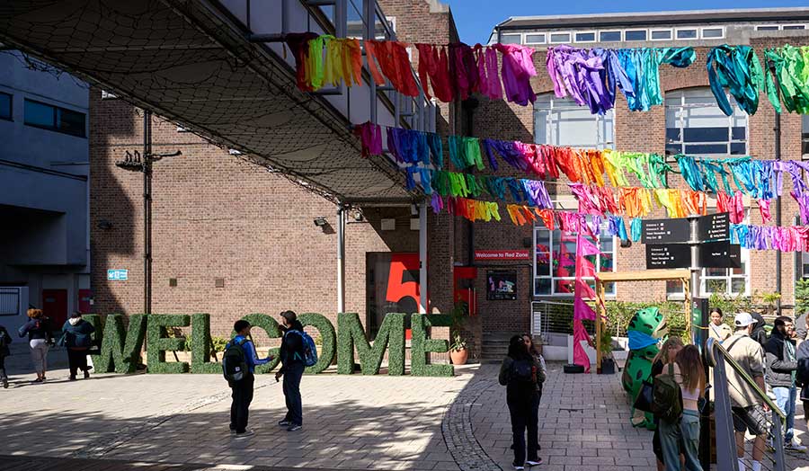 Holloway Road campus courtyard with bright banners and a crowd of new students