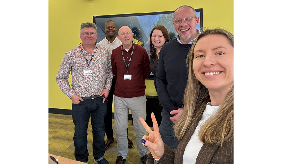 A group of men and women smiling at the camera