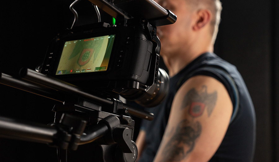 A person holds a professional video camera