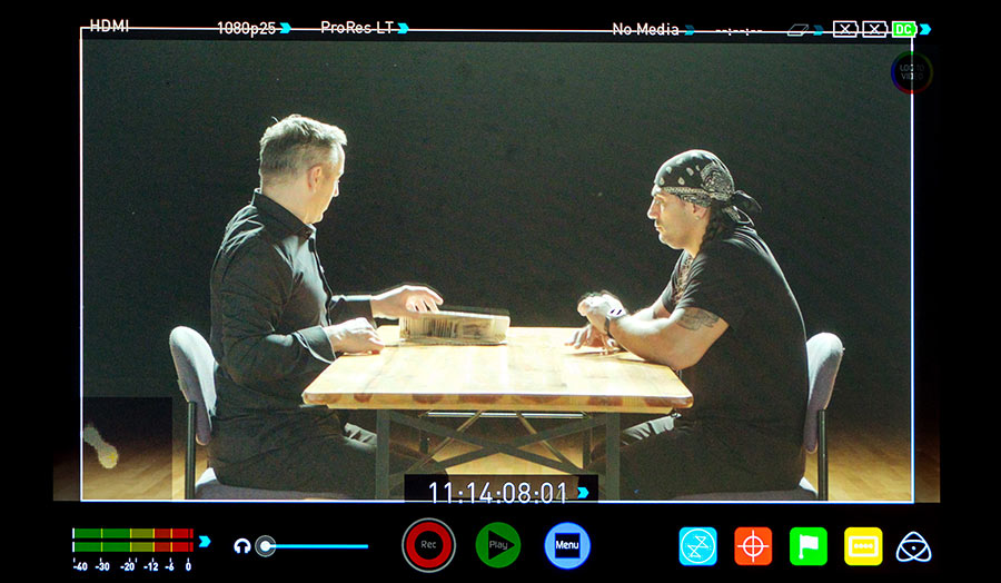 The preview screen of a digital camera, which shows two people sitting at a table