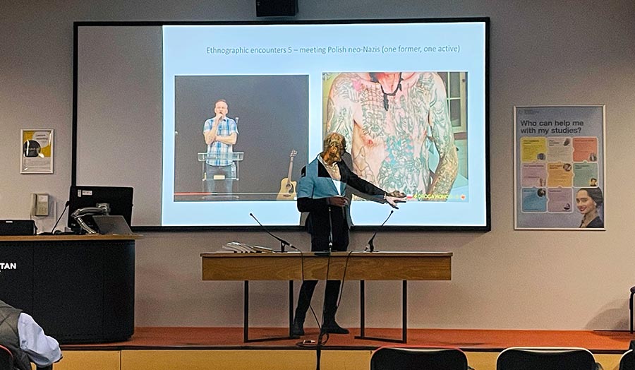 A person presenting a paper at a conference