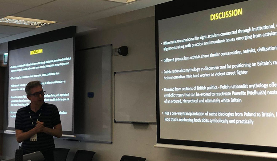 A person presenting a paper at a conference