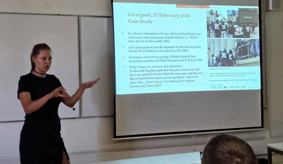 A person presenting a paper at a conference