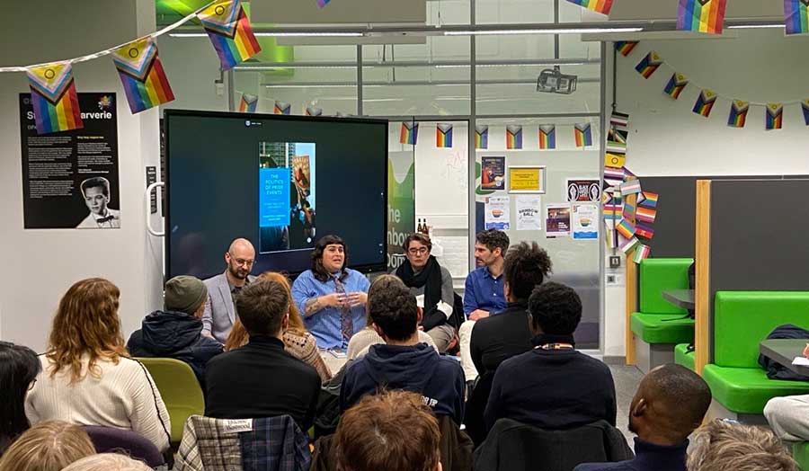 Four people speak to an audience