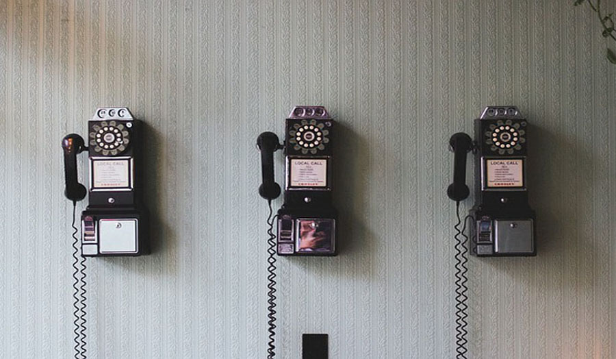 Old fashioned telephones mounted on a wall