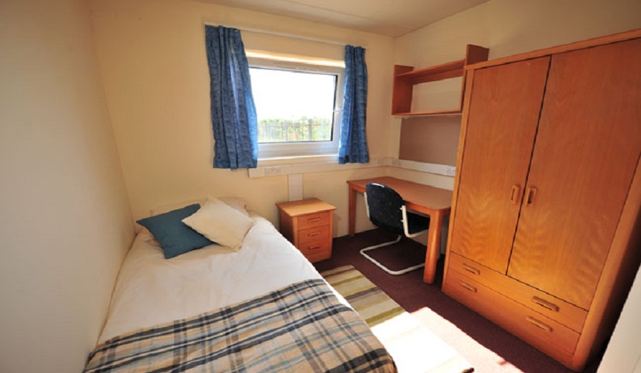 Photograph of a bedroom at Robbins Hall.