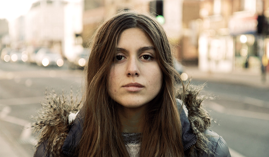 Girl in coat against street background