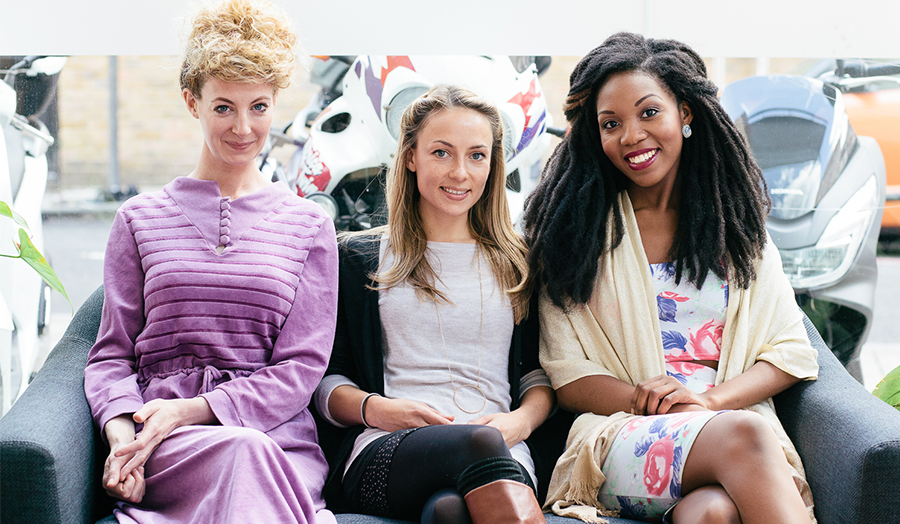 Three female winners sitting on a sofa at the Accelerator