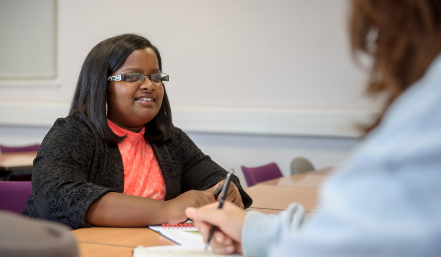 A female student talking to another student