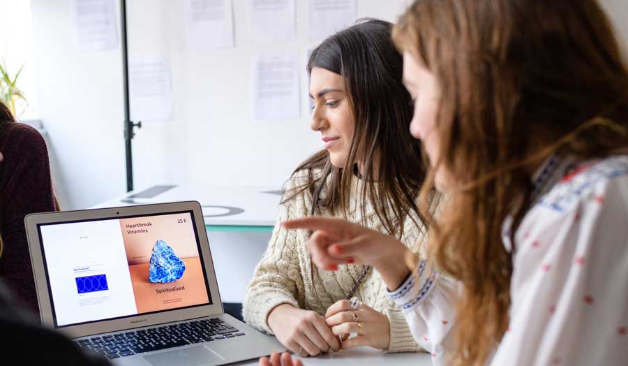 two female students looking at the computer