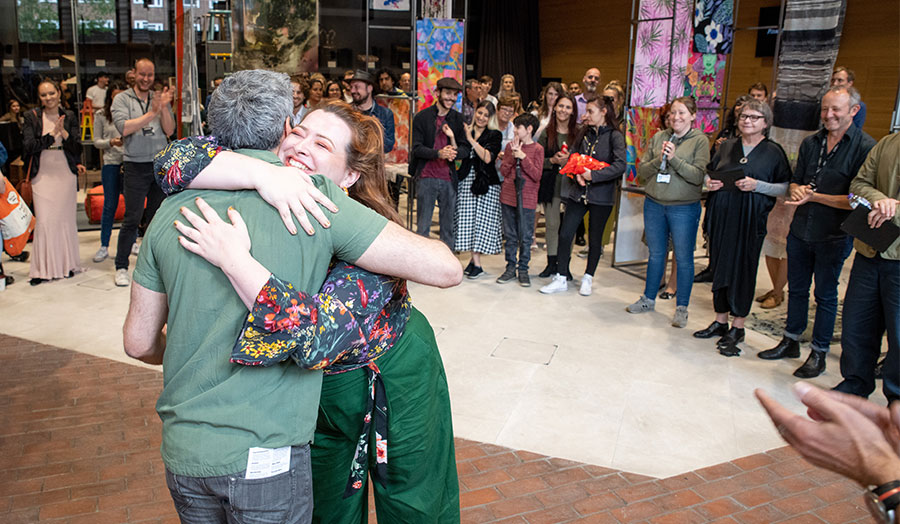 A London Met student hugging at an awards presentation