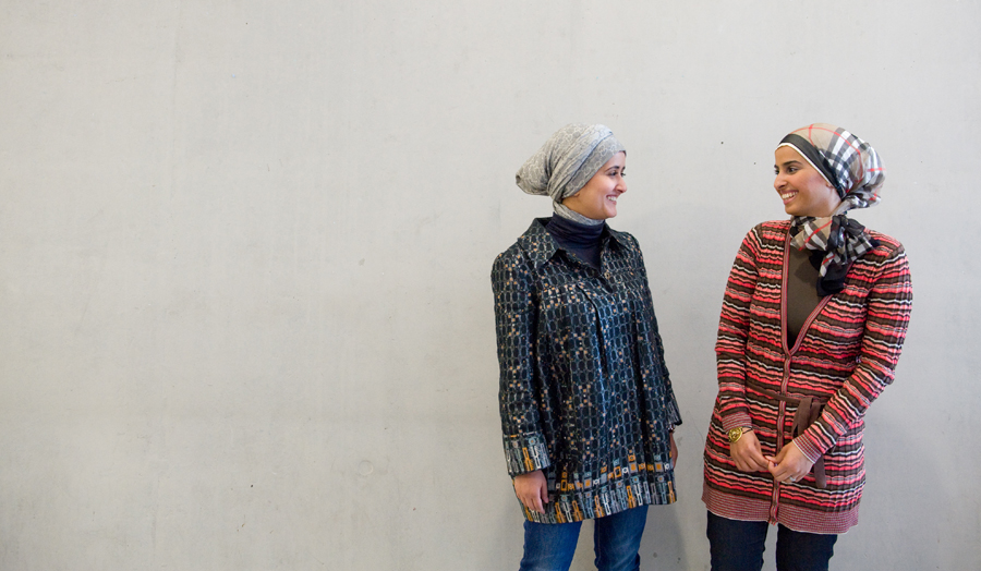 Two female students conversing and laughing