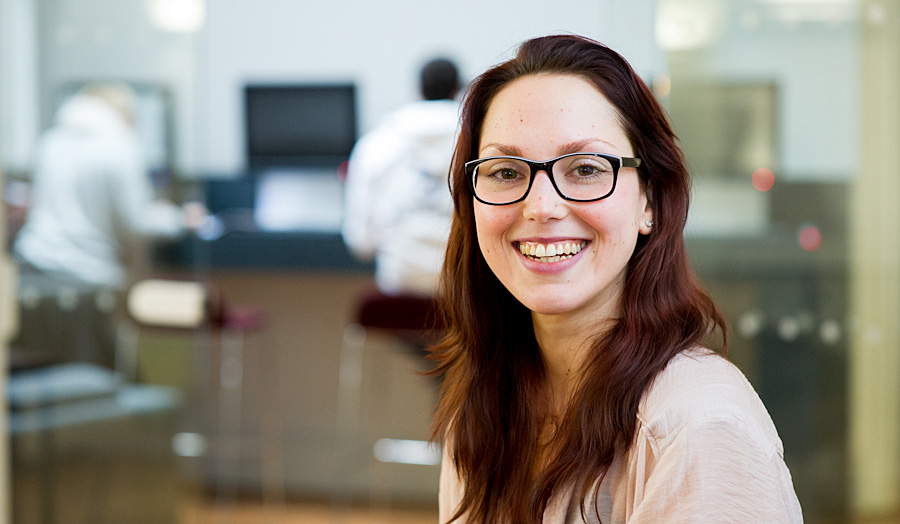 Postgraduate female student smiling with glasses