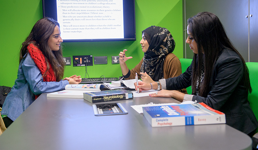 Three students talking in the green study zone