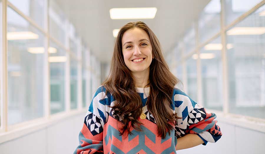 Picture of Alessia in a London Met Uni corridor, smiling