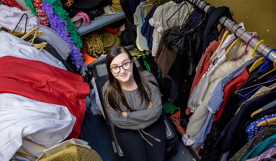 Photograph of female student Amy Vinten in London Met's costume room