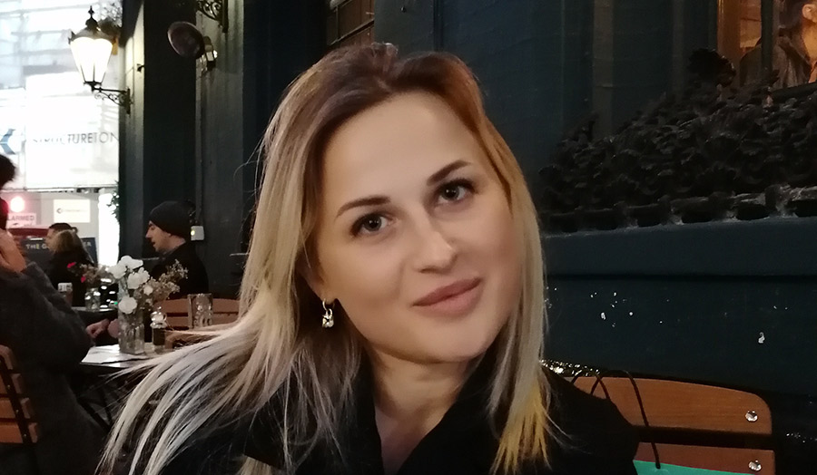Photo of Diana Milkat in a cafe, smiling