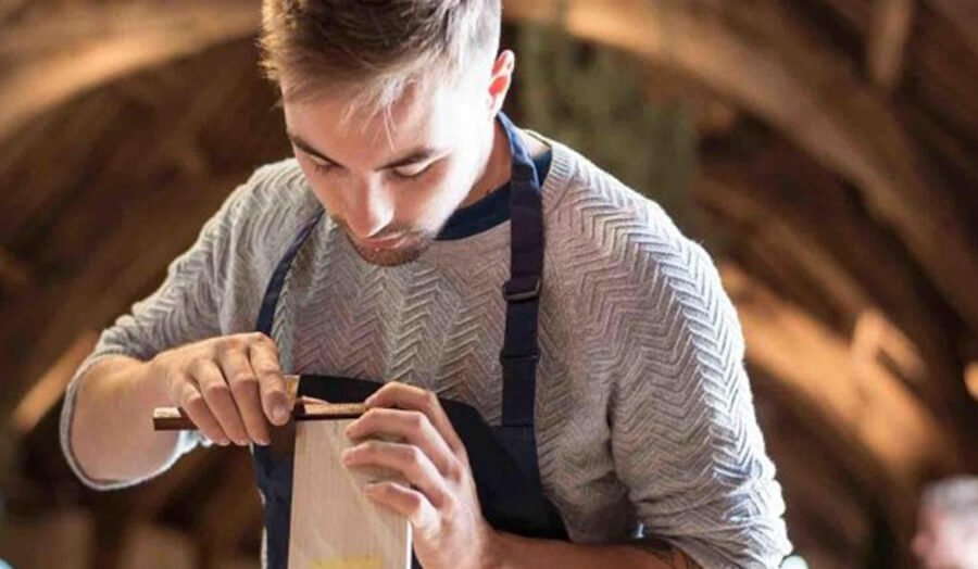 Photo of Diggory Rush working with a piece of wood