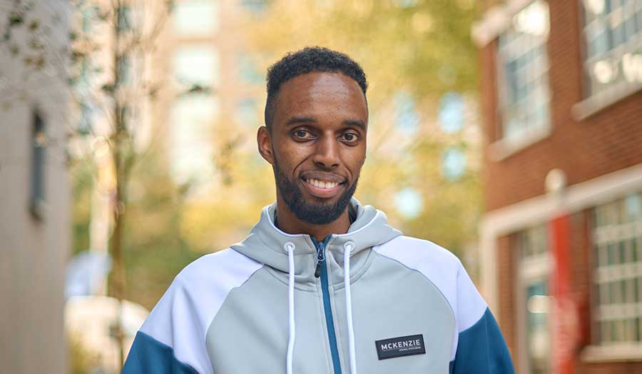 Kamal smiling outside Holloway Road campus