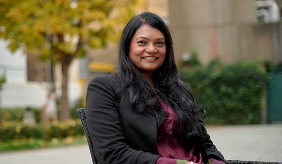 Smiling image of Medah in London Met's courtyard