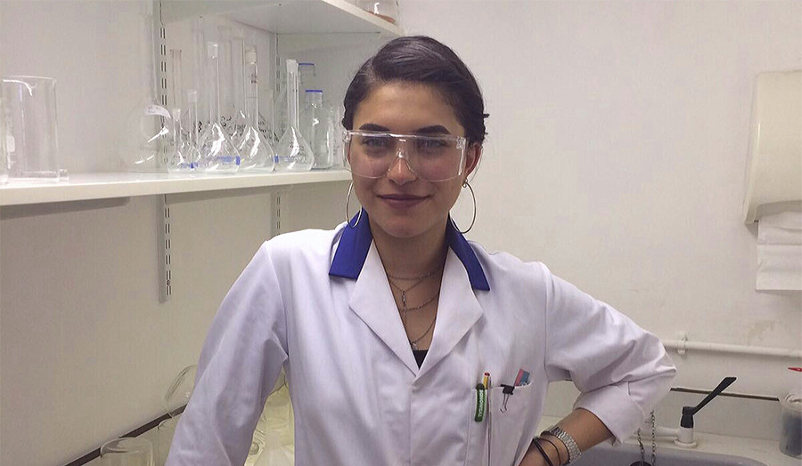 Image of female student Rand Turki in a lab coat