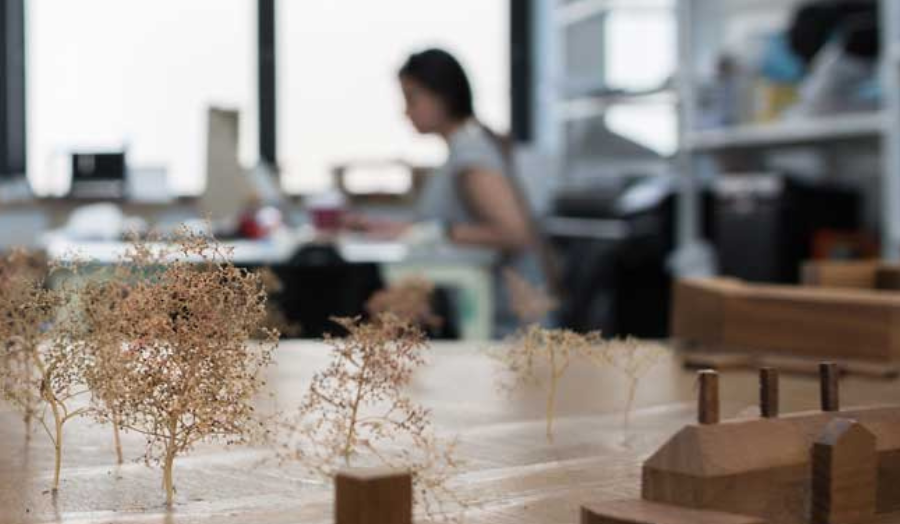 Architecture model with trees, with student in the background
